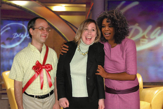 Oprah celebrates with Stacy Feuerbach of Downers Grove, IL, who was given Daniel Berenbaum (left).